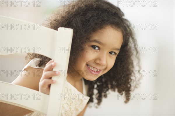 Portrait of smiling girl (6-7) with afro.