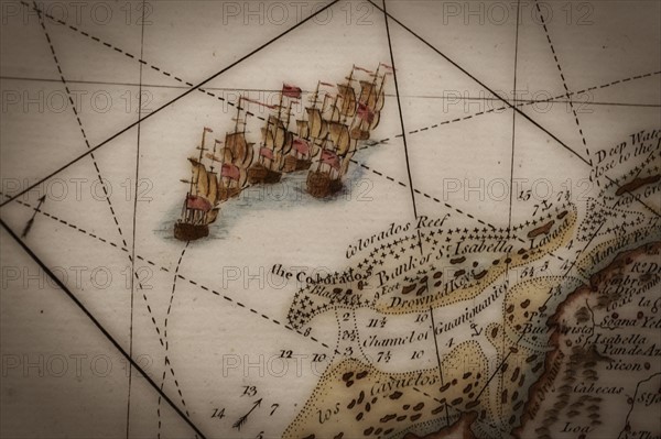 Close up of antique map of coastline of England with tall ships.