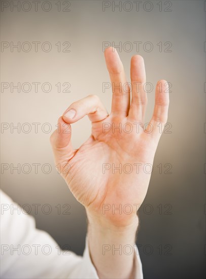 Hand showing okay sign. Photo : Jamie Grill Photography