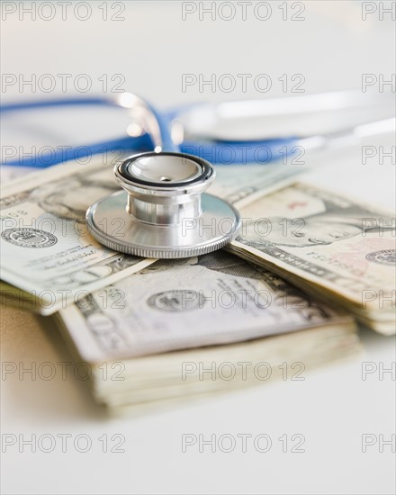 Studio shot of stethoscope on banknotes. Photo: Jamie Grill Photography