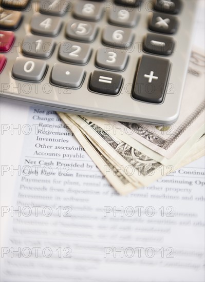 Studio shot of documentMoney and calculator. Photo : Jamie Grill Photography