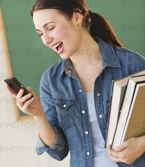 Female student using cell phone. Photo : Daniel Grill