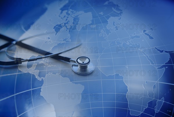 Close up of stethoscope with world map in background.