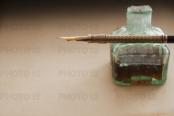 Close up of antique ink well and pen.