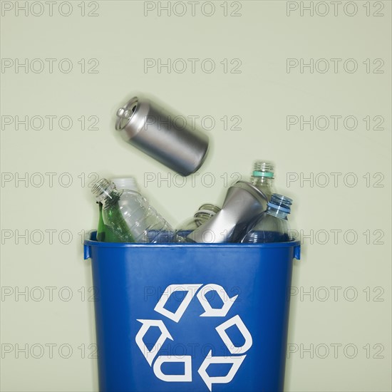 Close up of bottles and cans in recycle container.