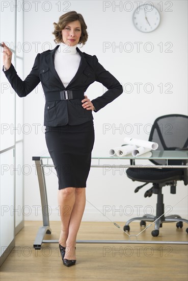 Businesswoman posing in office.