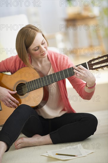 Woman playing guitar.