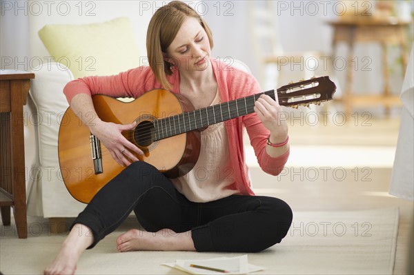 Woman playing guitar.