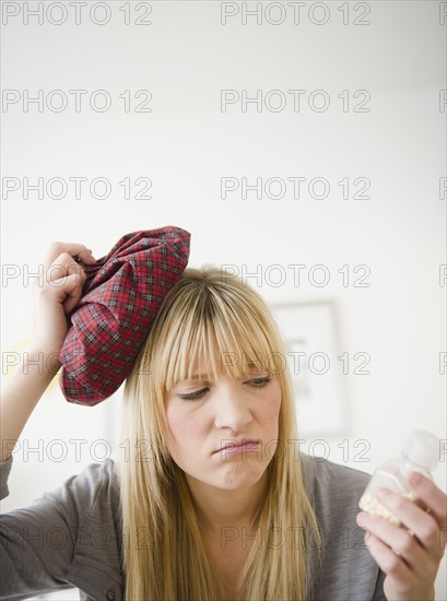 Young woman having headache. Photo : Jamie Grill Photography