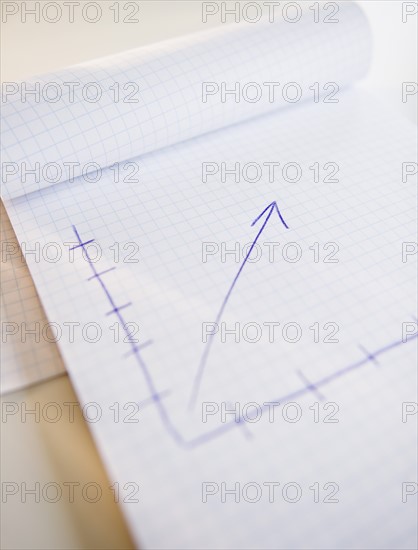 Studio shot of arrow graph in notepad. Photo : Jamie Grill Photography