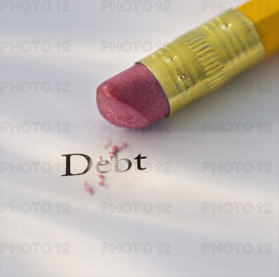 Studio shot of pencil erasing the word debt from piece of paper. Photo : Daniel Grill