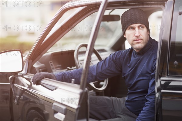 Man in workout wear getting out of truck. Photo : Take A Pix Media