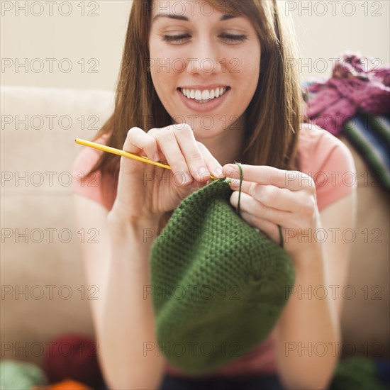 Young woman knitting woolly hat. Photo: Mike Kemp