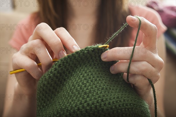 Young woman knitting woolly hat. Photo: Mike Kemp