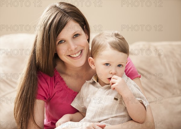 Gortrait of mother with son (2-3) on sofa. Photo: Mike Kemp