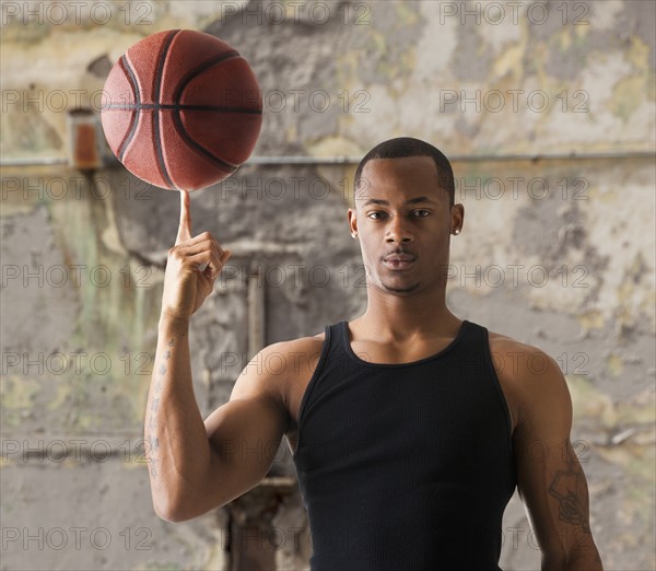 USA, Utah, Salt Lake City, Portrait of young man with basketball. Photo : Mike Kemp