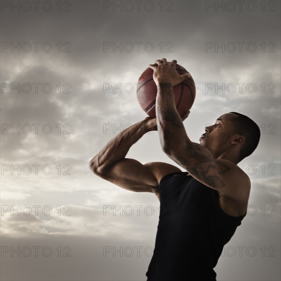 Young man playing basketball. Photo: Mike Kemp