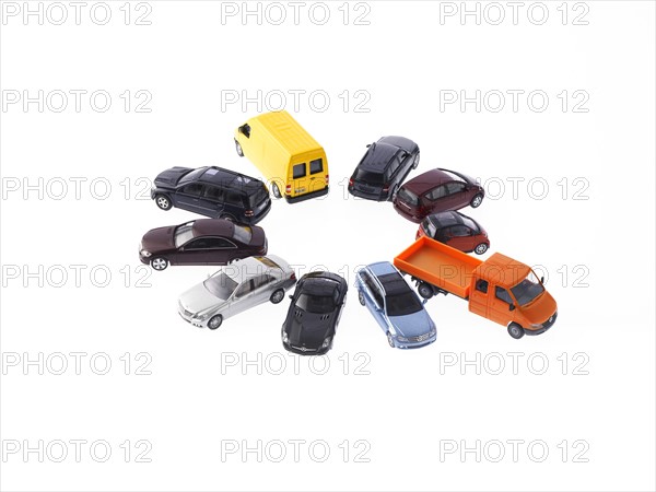 Circle of different cars on white background. Photo : David Arky