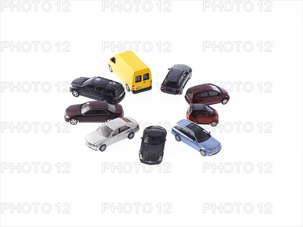 Circle of different cars on white background. Photo : David Arky