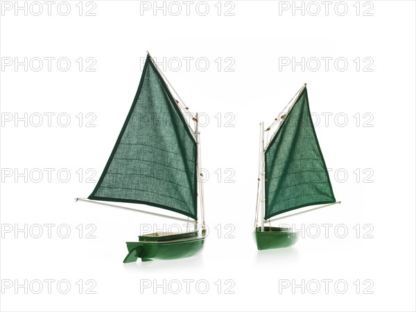 Two toy boats on white background. Photo : David Arky