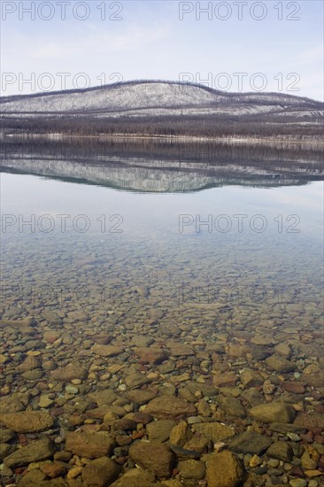 USA, Colorado, Hills reflected in lake. Photo: Noah Clayton