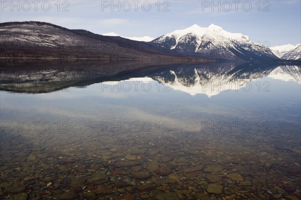 USA, Colorado, Mountains reflected in lake. Photo: Noah Clayton