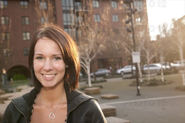 USA, Oregon, Portrait of smiling young woman outdoors. Photo: Gary Weathers