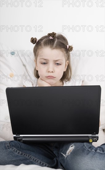 Girl (6-7) sitting with laptop. Photo: Justin Paget