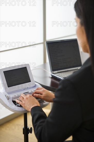 Court stenographer using stenograph machine. Photo: Daniel Grill