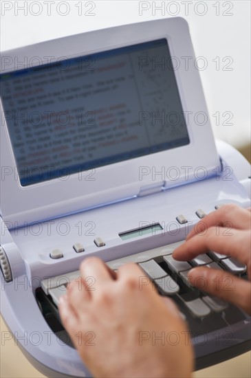 Court stenographer using stenograph machine. Photo : Daniel Grill