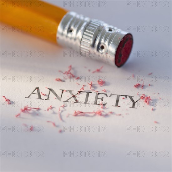 Studio shot of pencil erasing the word anxiety from piece of paper. Photo : Daniel Grill