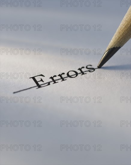 Studio shot of pencil crossing out the word errors from piece of paper. Photo: Daniel Grill