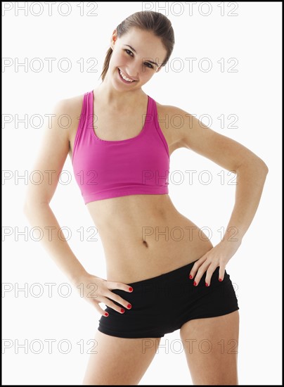 Studio portrait of young woman exercising. Photo : Mike Kemp