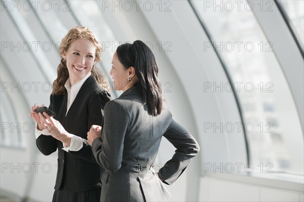 Businesswomen using at cell phone. Photo: Mark Edward Atkinson