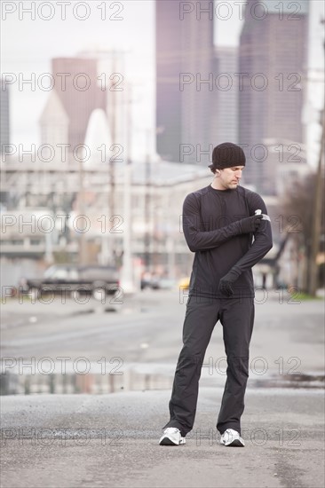 USA, Washington, Seattle, man in workout wear in street. Photo : Take A Pix Media