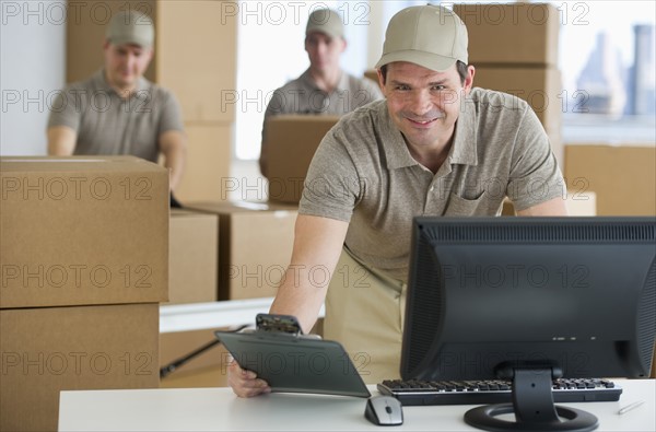 Man checking checklist in warehouse.