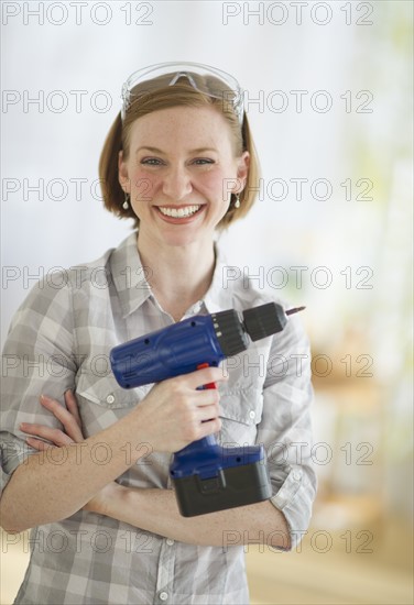 Woman holding drillPortrait.