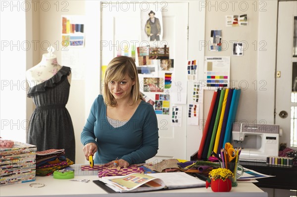Female fashion designer working in studio. Photo : DreamPictures