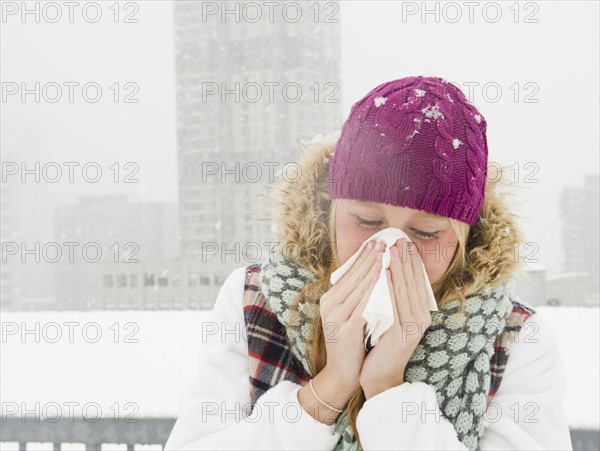 USA, New Jersey, Jersey City, woman blowing nose. Photo : Jamie Grill Photography