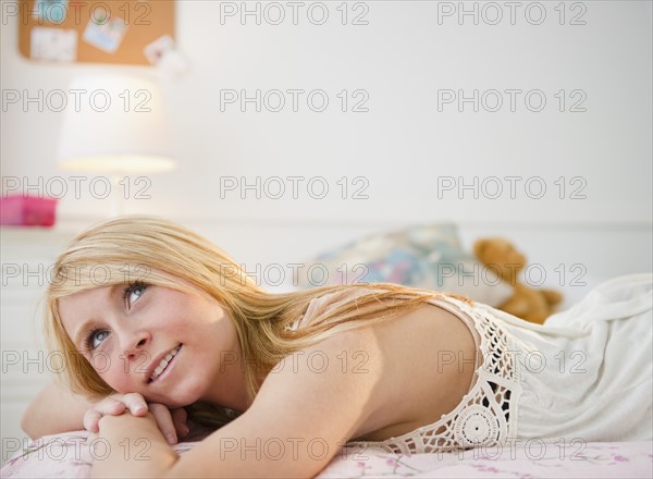 Woman relaxing in bed. Photo: Jamie Grill Photography