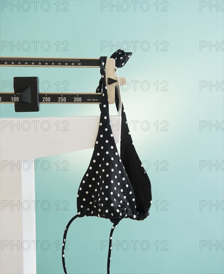 Bikini hanging on weight scale. Photo: Jamie Grill Photography