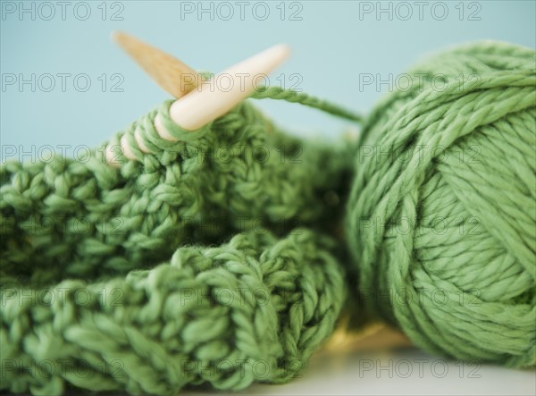 Close-up of green knitwear and yarn. Photo : Jamie Grill Photography