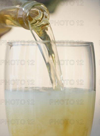 Pouring beer into pint glass. Photo : Jamie Grill Photography
