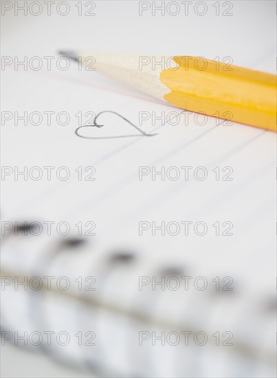 Close-up of pencil and notebook with heart drawing. Photo : Jamie Grill Photography