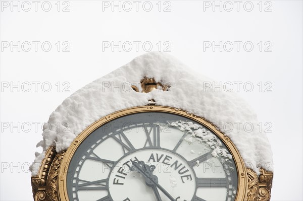 USA, New York, New York City, close up of antique clock covered with snow.