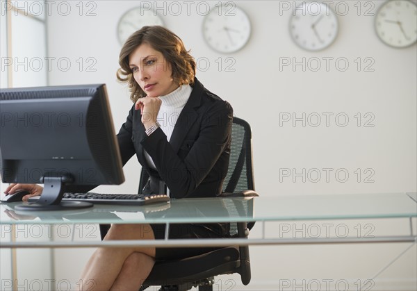 Businesswoman working at desk in office.