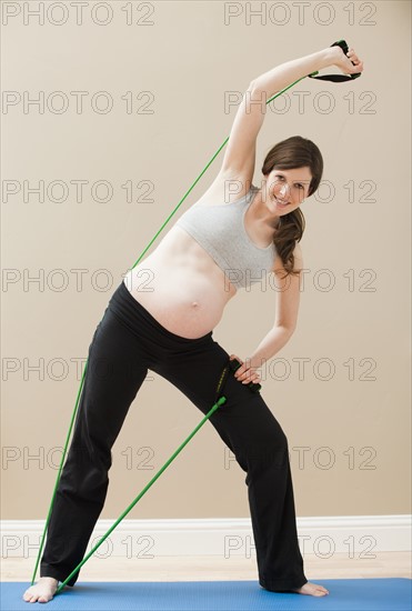 Young woman stretching with skipping-rope. Photo : Mike Kemp