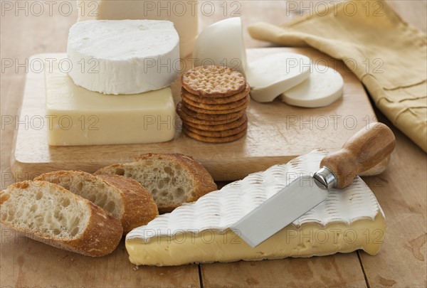 Various cheeses and bread on table.