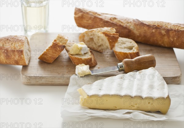 Cheese and baguette on table.