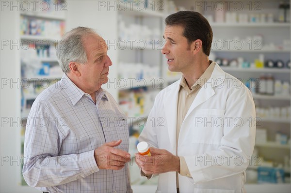 Pharmacist explaining use of medicine to patient.